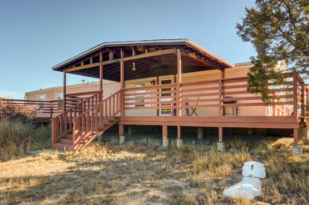a large wooden house with a large deck at Peaceful Sandia Park Retreat with Deck and Views! in Sandia Park