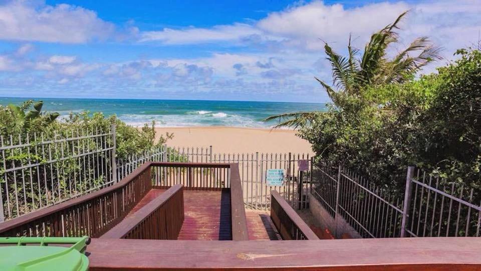 a stairway to the beach with the ocean in the background at 104 Santana Resort, Margate Beach in Margate