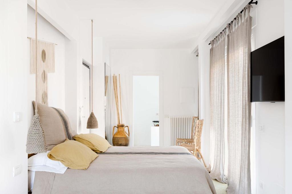 Postel nebo postele na pokoji v ubytování Sole Suites