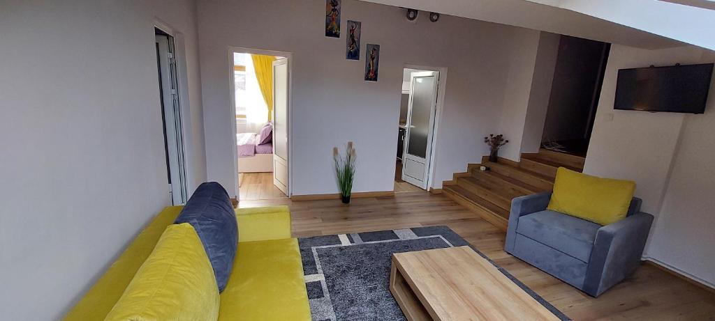 a living room with a couch and a chair at Central Palace Iași Apart in Iaşi