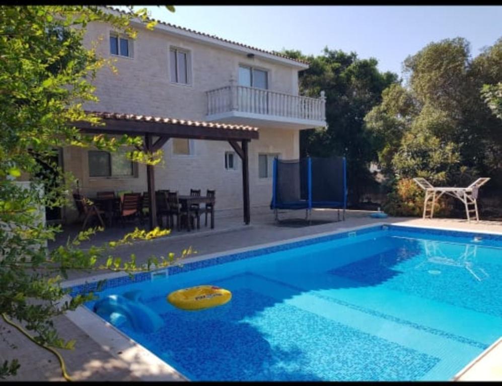 een zwembad voor een huis bij A villa located in the middle of the mountains .. in Trimitusa