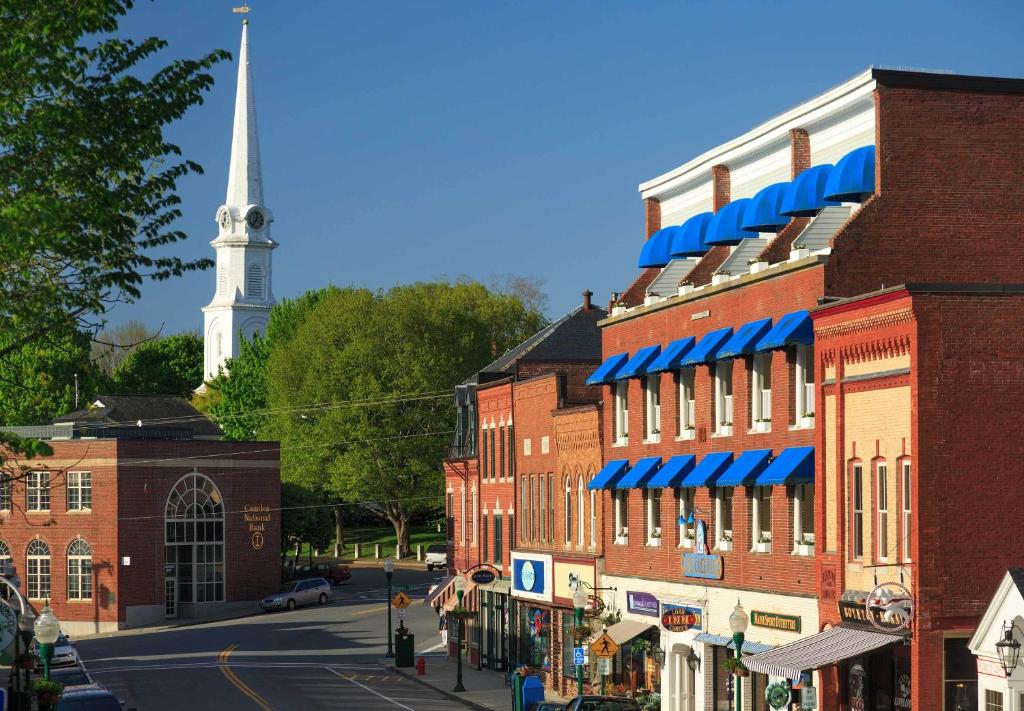 a street in a small town with a church steeple at Lord Camden Inn in Camden