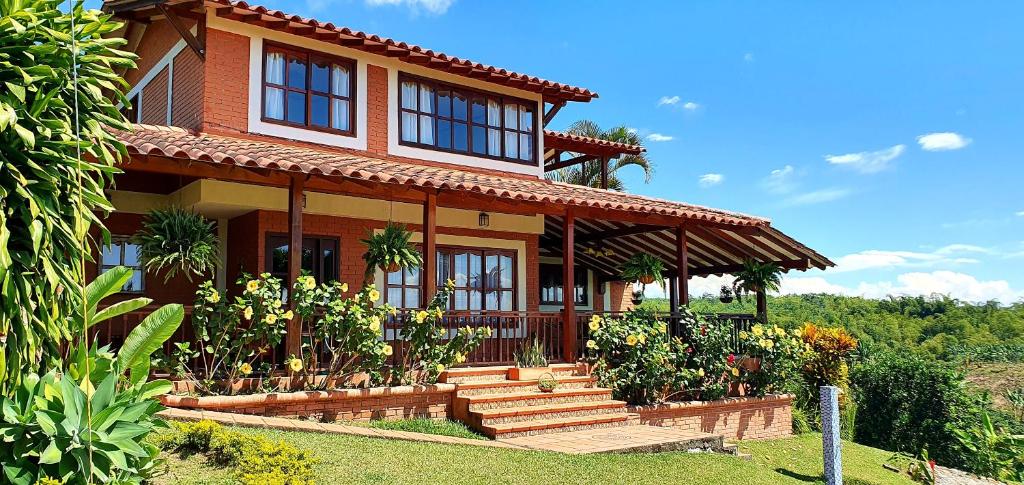 a house with stairs in front of it at Finca Bellavista Pereira in Pereira