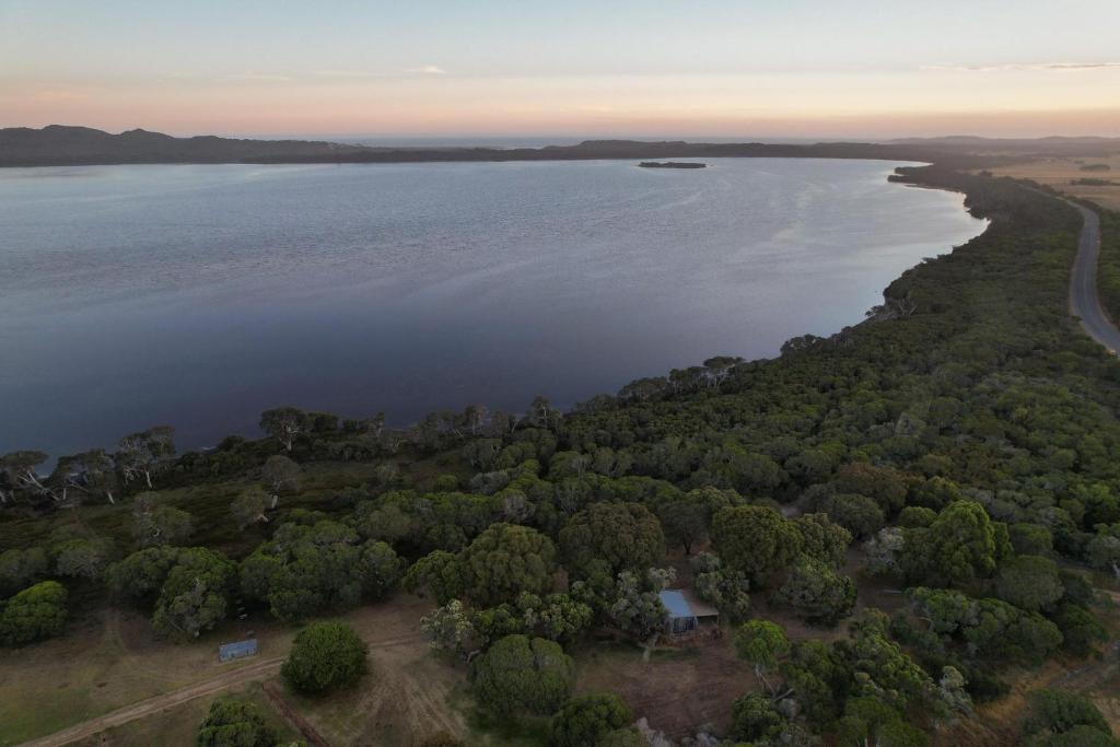 an aerial view of a lake with trees at Peacehaven Chalet on the Irwin Inlet in Bow Bridge