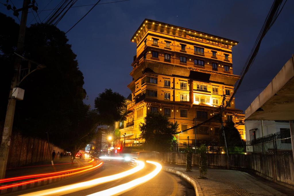 a tall building on a city street at night at Basera Boutique Hotel in Kathmandu