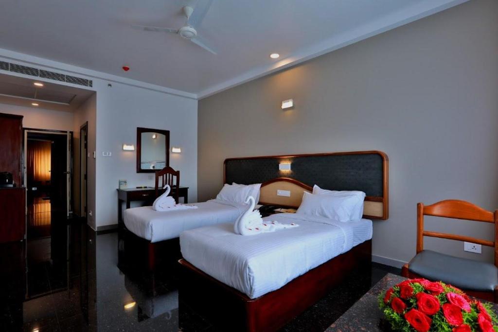 Postel nebo postele na pokoji v ubytování Lemongrass inn munnar