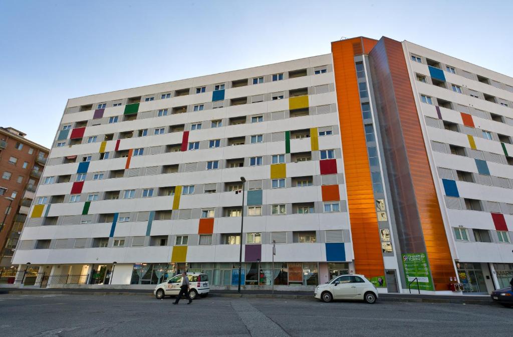 a large building with colorful windows on the side of it at Hotel Sharing in Turin