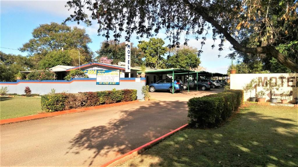 a car parked in a parking lot next to a building at Affordable Gold City Motel in Charters Towers