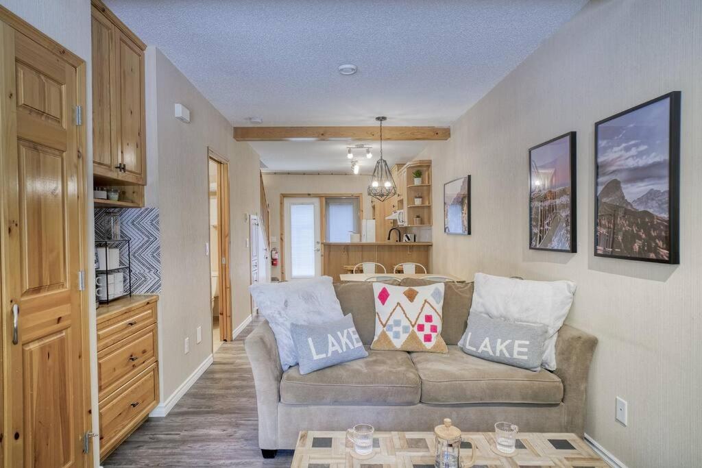 a living room with a couch and a table at 5 Mins to Banff - Cozy Townhome 2BR&2BATH - Banff Pass Included in Canmore