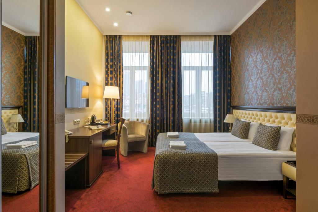 Postel nebo postele na pokoji v ubytování Congress Hotel