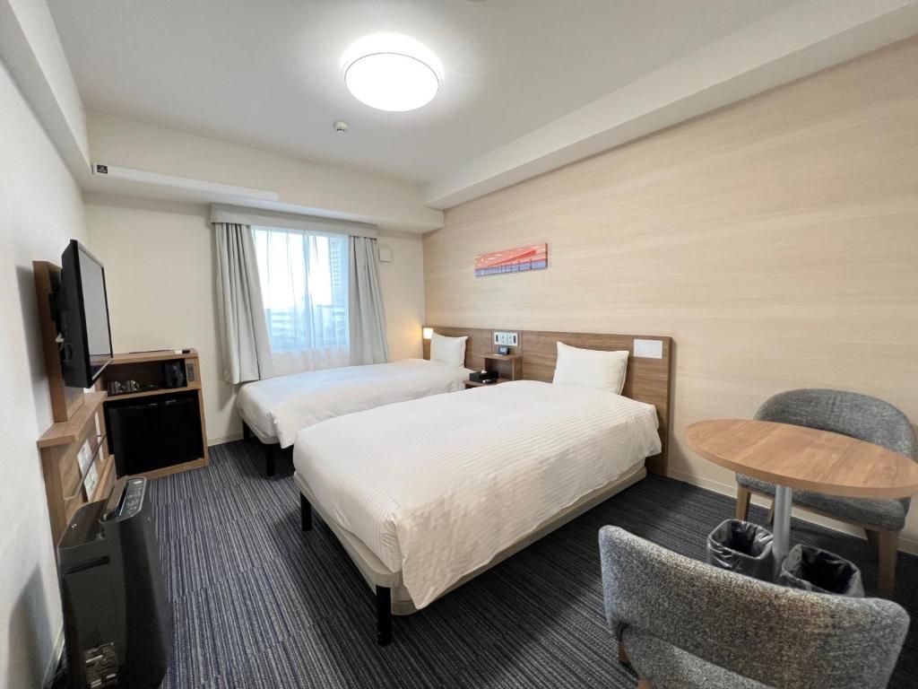 Postel nebo postele na pokoji v ubytování Tabino Hotel Kashima