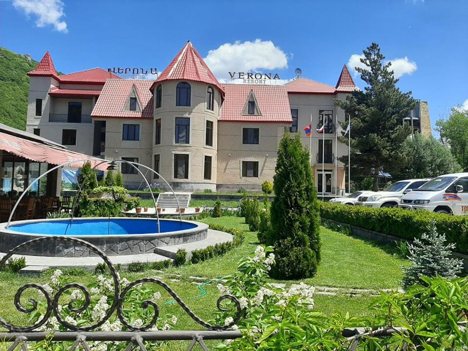 a view of a building with a pool in a yard at Jermuk Verona Resort in Jermuk