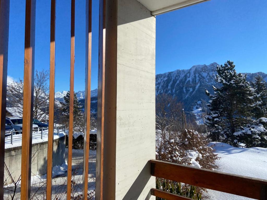 a balcony with a view of a snow covered mountain at Rose des Alpes in Leysin