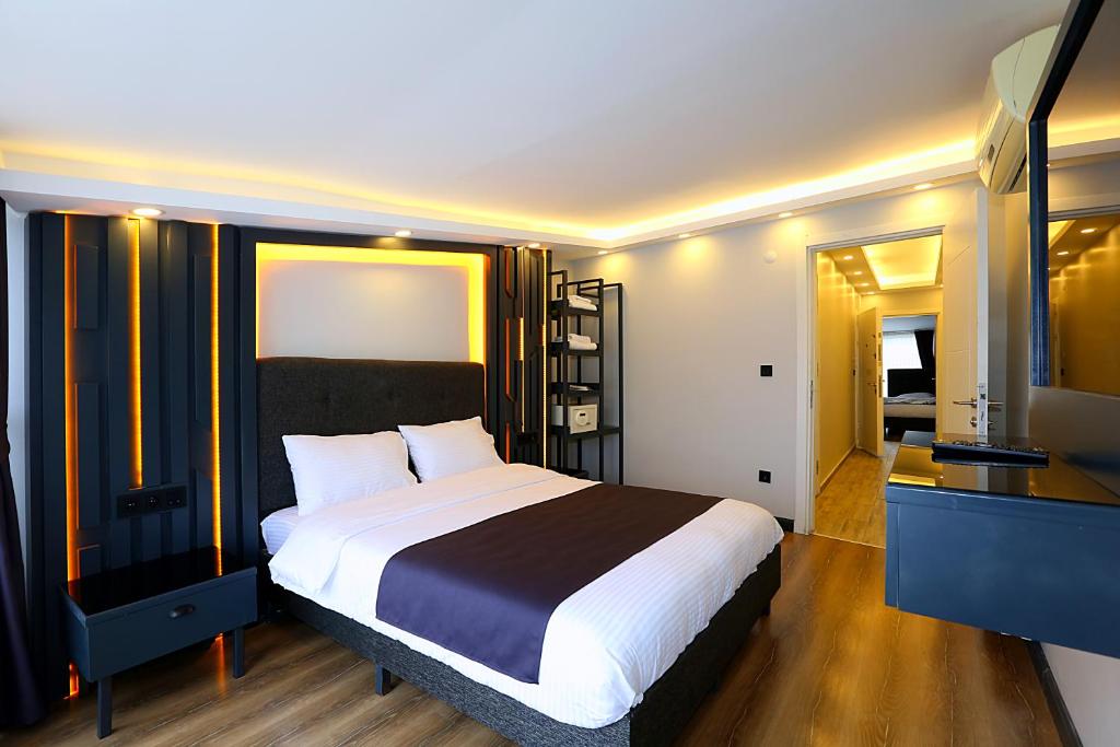 a bedroom with a bed and a desk and a television at Galata King Suite Hotel in Istanbul