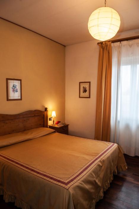 Postel nebo postele na pokoji v ubytování Hotel Melecchi