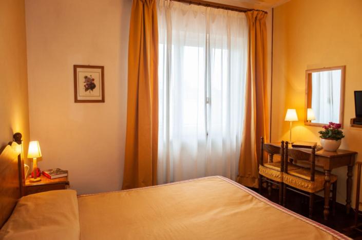 Postel nebo postele na pokoji v ubytování Hotel Melecchi