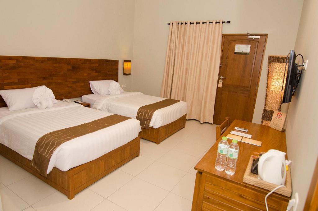 Letto o letti in una camera di Syailendra Hotel Syariah