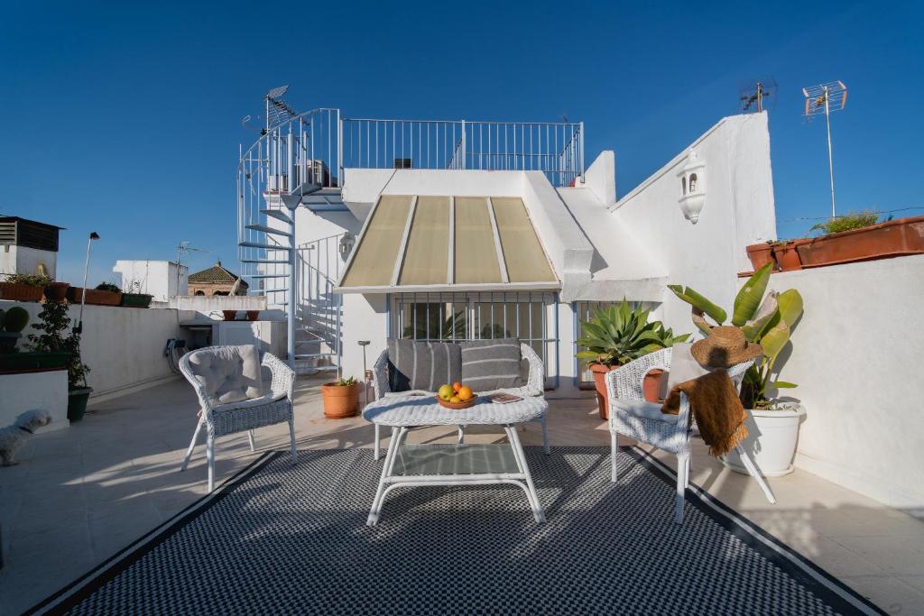 a patio with a table and chairs on a balcony at Eva Recommends Alameda Sevilla in Seville