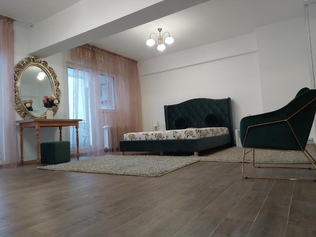a living room with a couch and a mirror at MosilorCentralBoutique in Bucharest