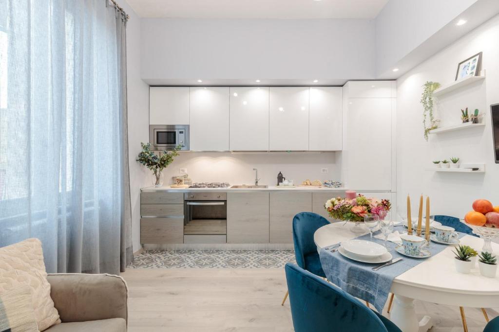 a kitchen and dining room with a table and chairs at Casa Versilia Style in Viareggio