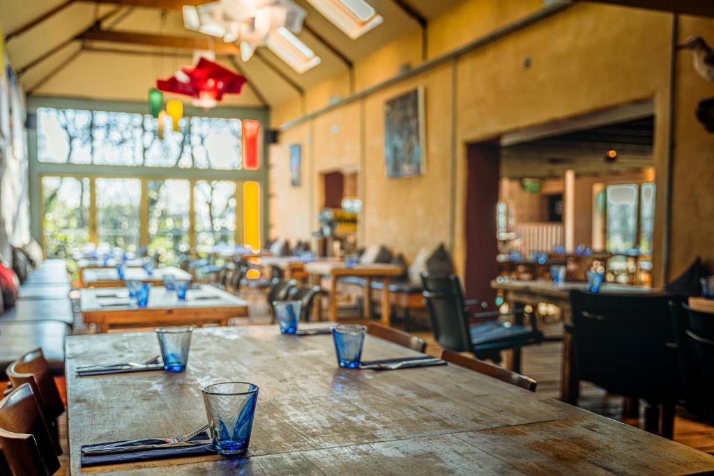 un restaurante con una mesa de madera con gafas. en The Sheppey, en Glastonbury