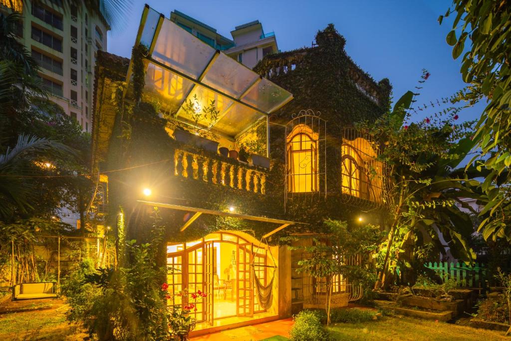 a large building with lights on it at night at SaffronStays Birdsong, Madh - pet-friendly villa at Madh Island in Mumbai