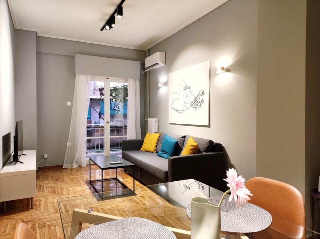 a living room with a couch and a table at Veno Apartments Goudi in Athens