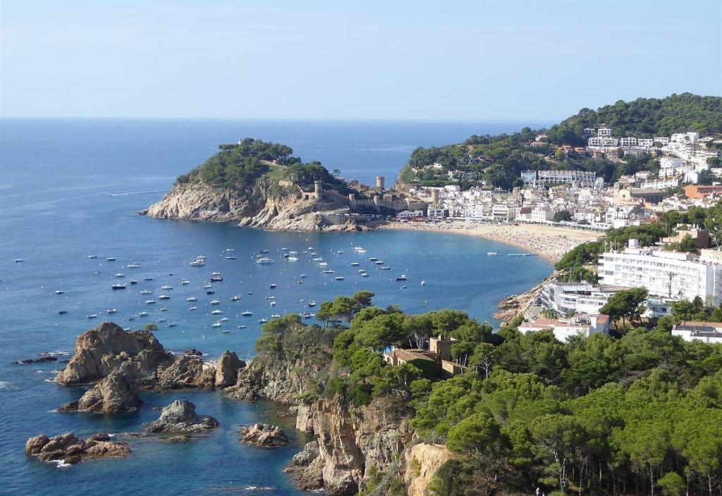 a view of a bay with boats in the water at Sunny apartment with pool in Tossa de Mar