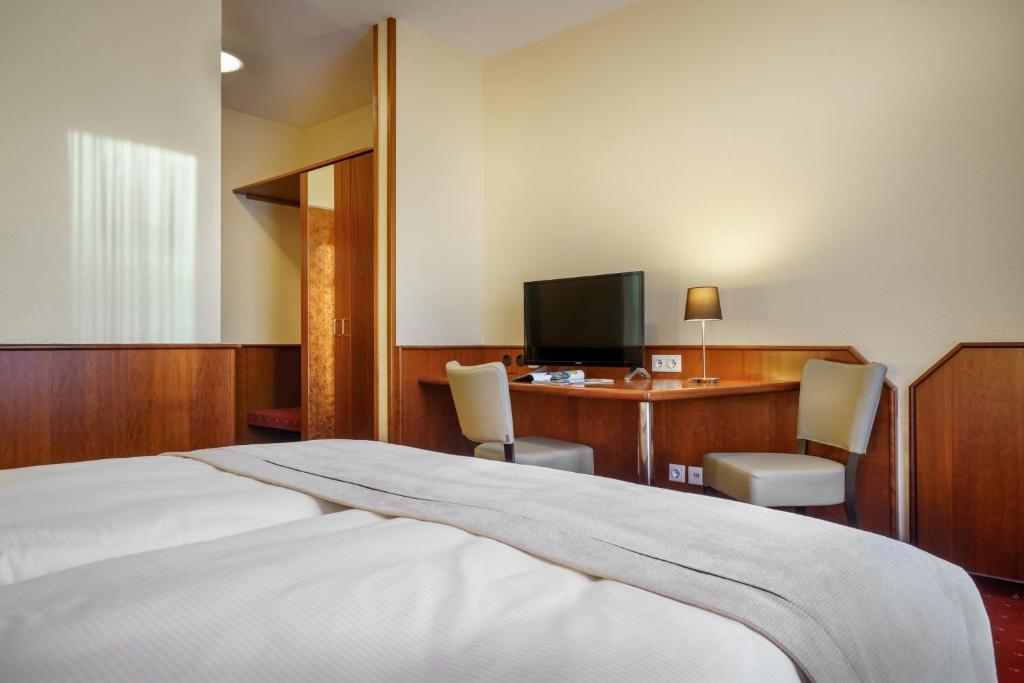 Postel nebo postele na pokoji v ubytování Hotel Hagemann Hamburg Hafen