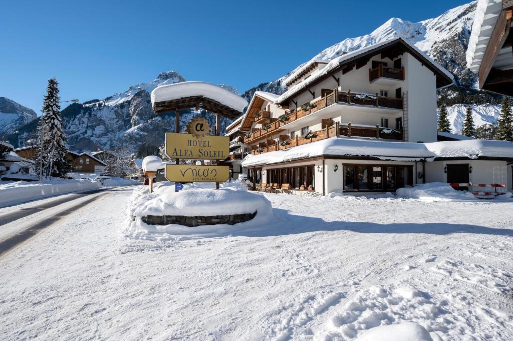 a snow covered street in front of a hotel at Seilers Vintage Hotel & Spa in Kandersteg