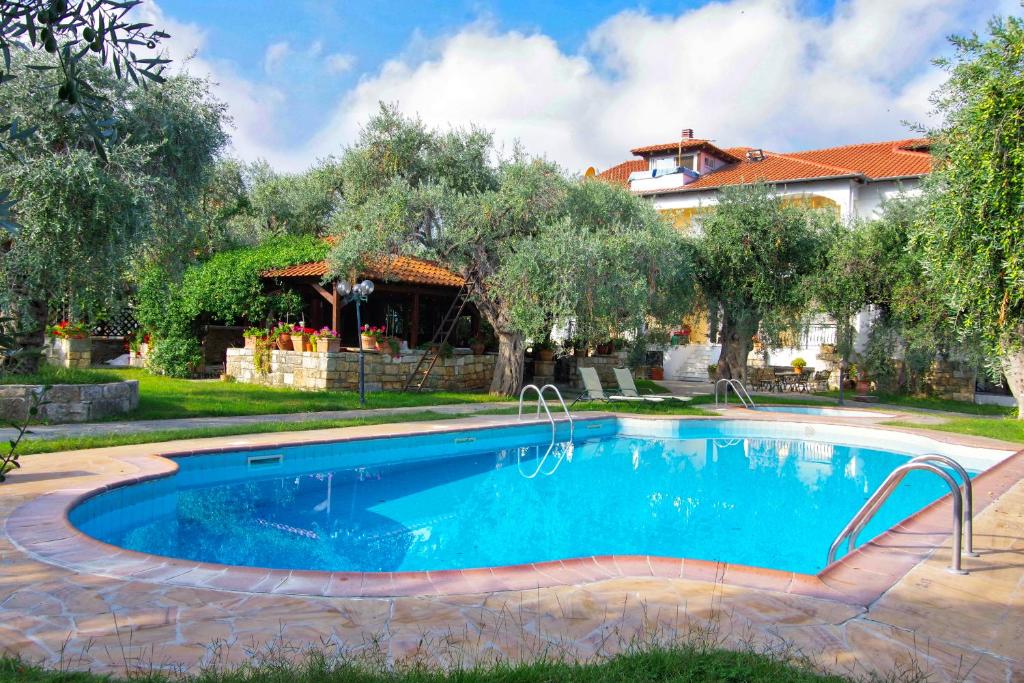 a swimming pool in a yard with a house at Effi's Garden Villa in Limenas