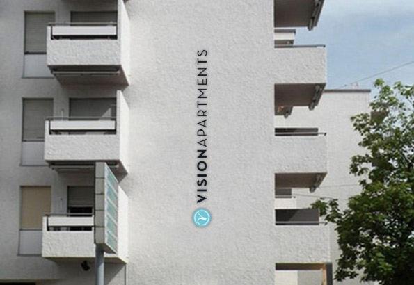 a building with a sign on the side of it at VISIONAPARTMENTS Binzmühlestrasse 46 - contactless check-in in Zürich