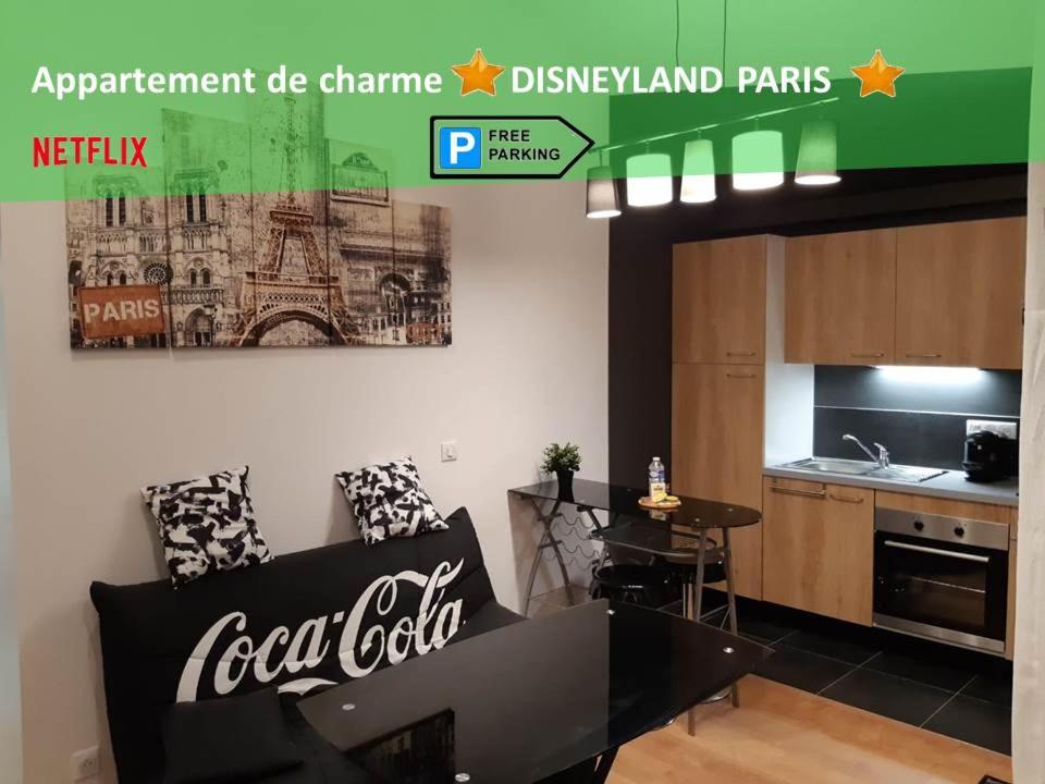 a living room with a cocacola painting on the wall at Appartement de charme DISNEYLAND PARIS - Nidouest in Chanteloup-en-Brie