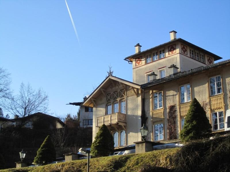 a large building on top of a hill at Königliche Villa - Turmappartement in Berchtesgaden