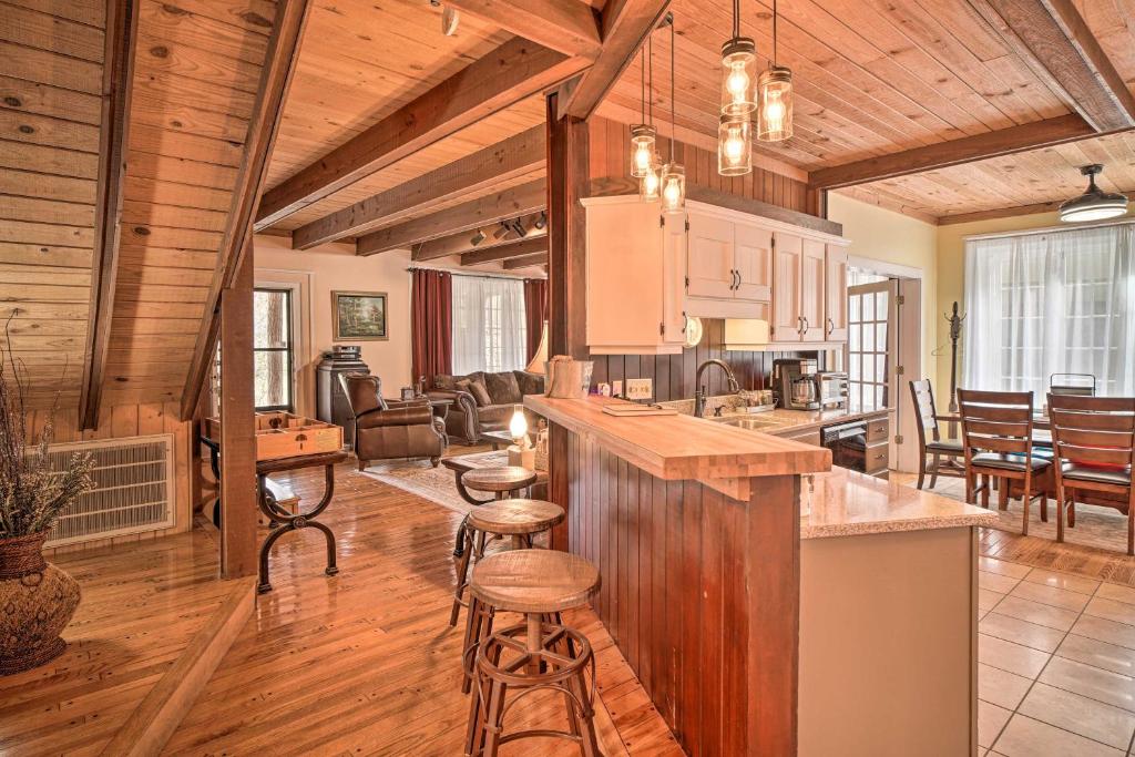 an open kitchen and living room in a log cabin at Tranquil Smoky Mountain Cabin with Porch and Fire Pit in Newport