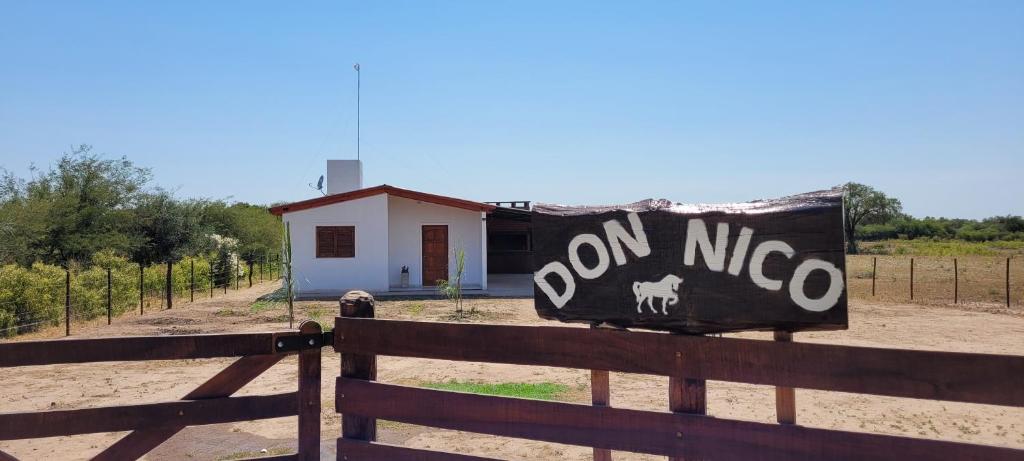 a house with a sign that reads on nico at Cabañas Don Nico in San José de la Dormida