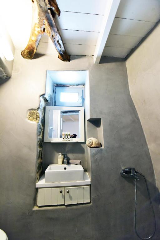 a bathroom with a sink and a mirror at Thomas Traditional House in Chora in Amorgos