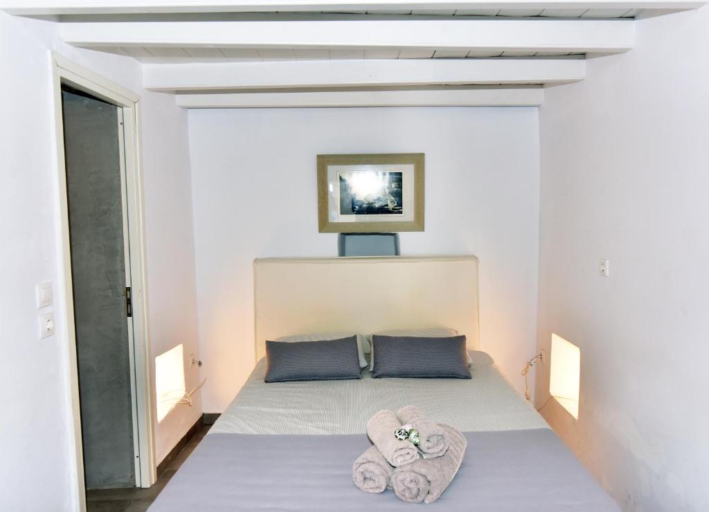 a bedroom with a bed with towels on it at Thomas Traditional House in Chora in Amorgos