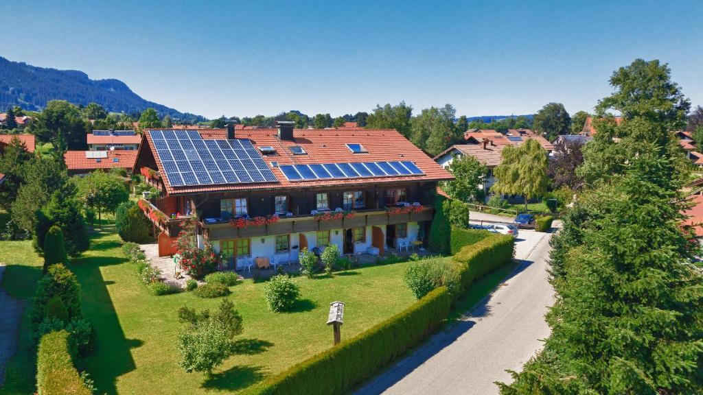 a house with solar panels on the roof at Appartementhaus Manhard in Pfronten