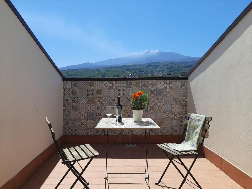 einen Tisch und zwei Stühle auf einem Balkon mit Aussicht in der Unterkunft La mia dolce casa in Mascali