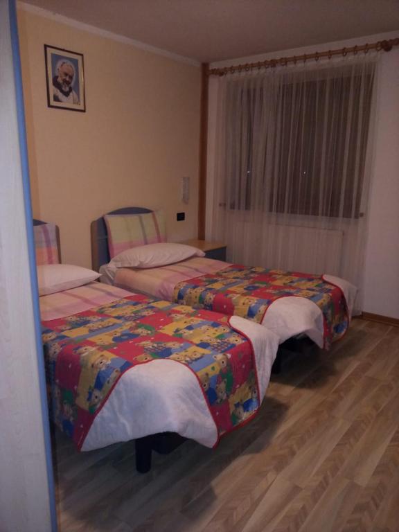 Postel nebo postele na pokoji v ubytování Hotel Genzianella