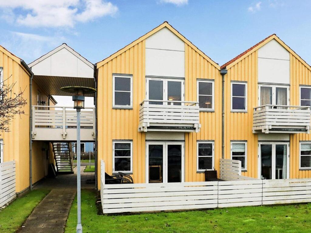 een huis met wit en oranje bij 4 person holiday home in Rudk bing in Rudkøbing