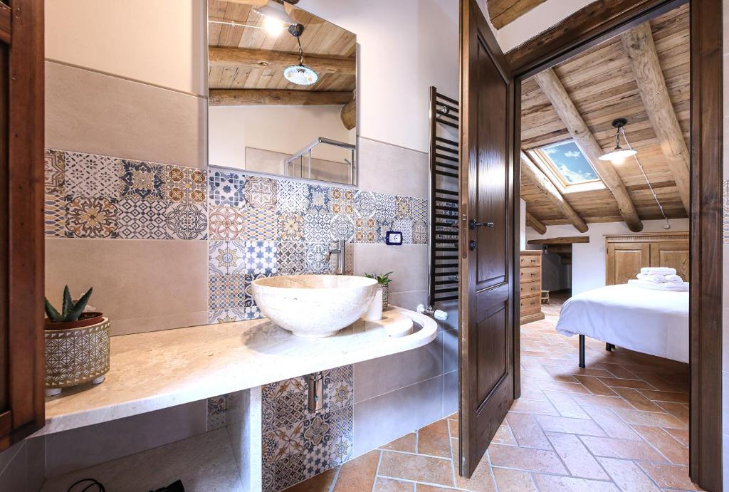 a bathroom with a sink and a bed in a room at Casa Sunalle in Fonni