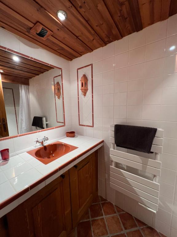 a bathroom with a sink and a mirror at Chalet Altus in Sainte-Foy-Tarentaise