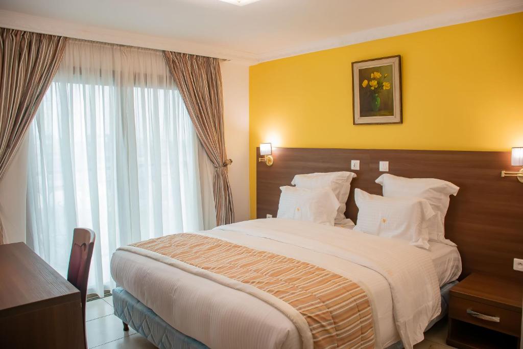 Postel nebo postele na pokoji v ubytování FAYA Hotel