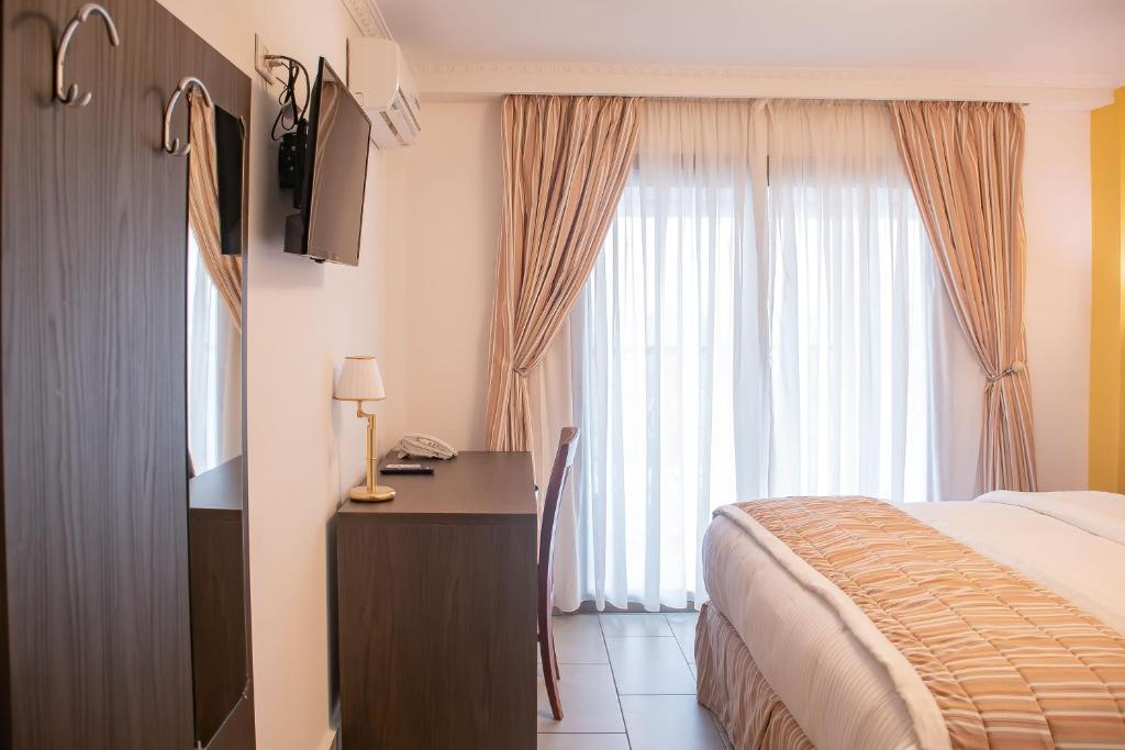 Postel nebo postele na pokoji v ubytování FAYA Hotel