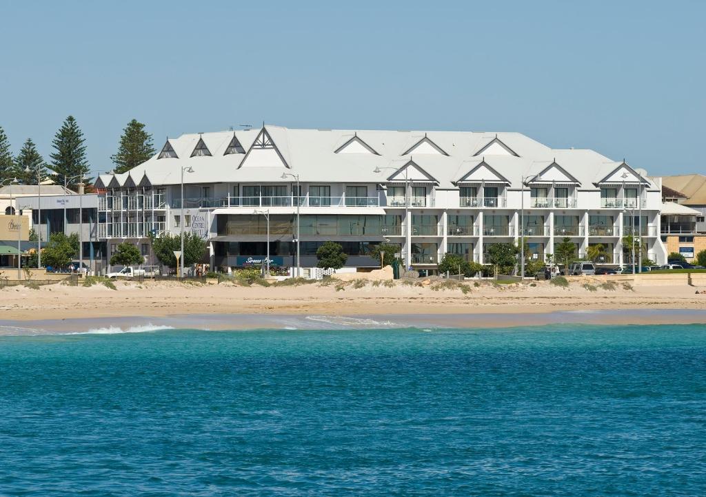 a large building on the beach next to the ocean at Ocean Centre Hotel in Geraldton