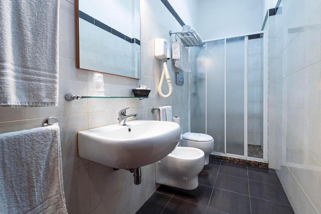 a bathroom with a sink and a toilet at Hotel Villa Romeo in Catania
