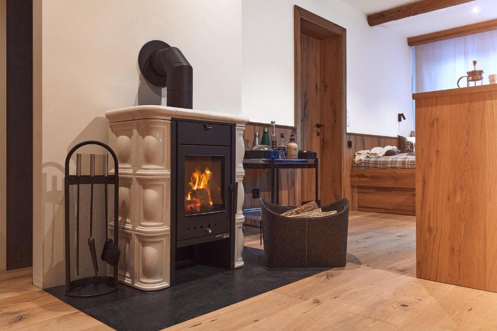 a living room with a fireplace in a room at Berghaus Schröcken - Hotel Apartments Spa in Schröcken