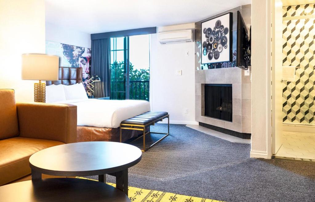 A suite with a balcony and a fireplace at the Montrose at Beverly Hills.